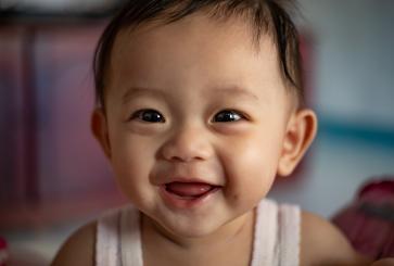 A portrait of happy smiling baby in Indonesia.