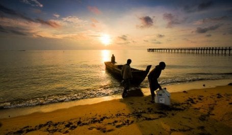 Fisherpeople come in at sunset at Sergang Laut. Flickr/Haryadi B