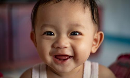 A portrait of happy smiling baby in Indonesia.